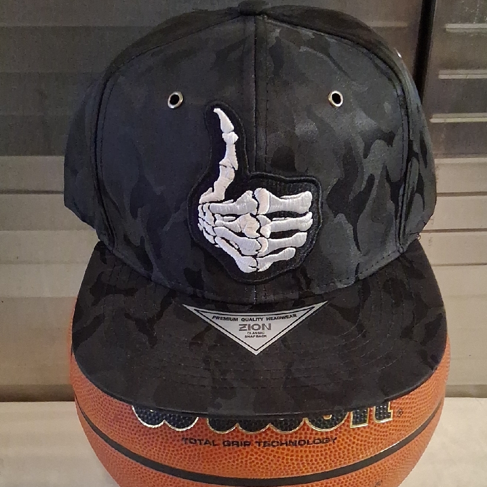 NWOT. Brand New. Never Worn. Black Camo Cap with Skeleton Hand Design